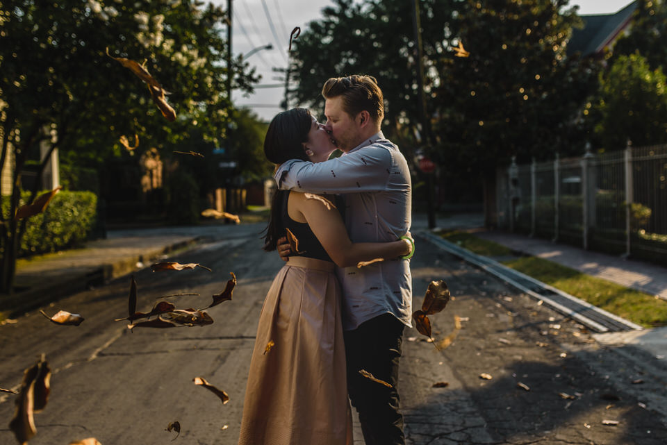 Magnolia leaves catch the wind in this engagement portrait in New Orleans' Garden District. | Photo by Sarah Alleman Photography.