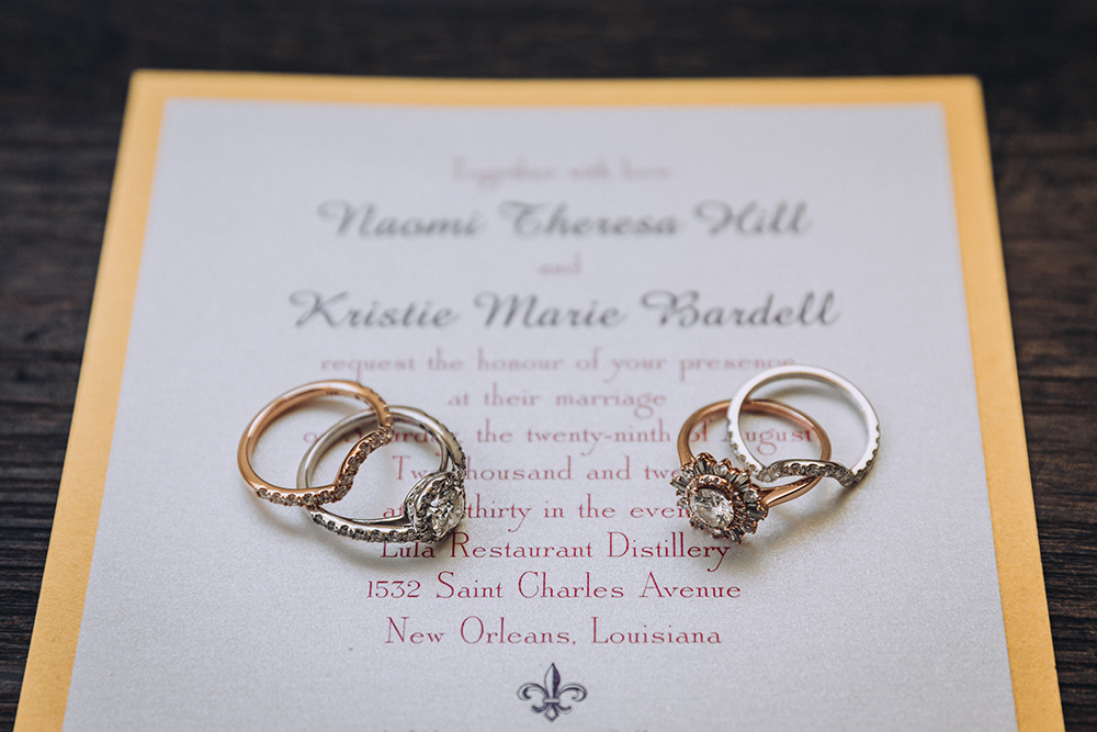 Naomi and Kristie's rings on their wedding invitation