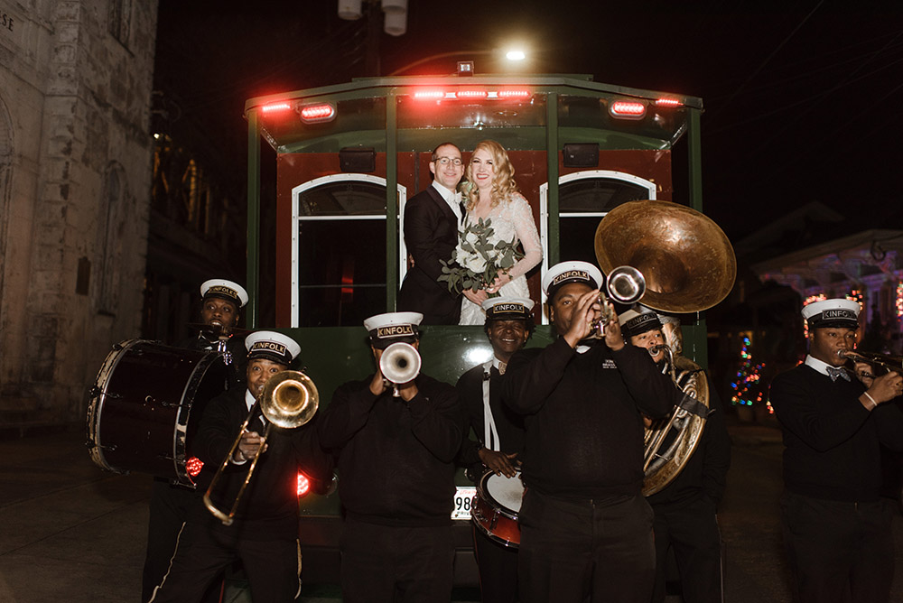Chelsea and Ross pose for a portrait on a Trolley with Kinfolk Brass Band.