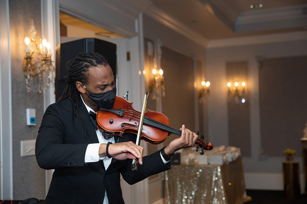 T-Ray the Violinist performs at Shonathan and Desmond's engagement party.