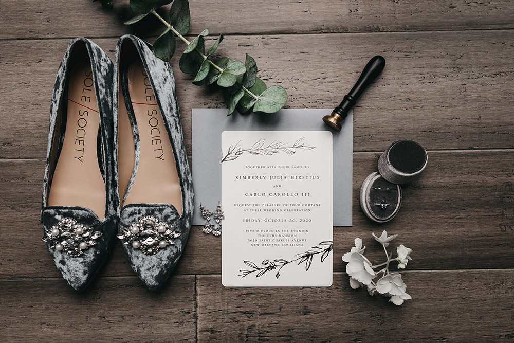 The wedding invitation with Kimberly's shoes and ring