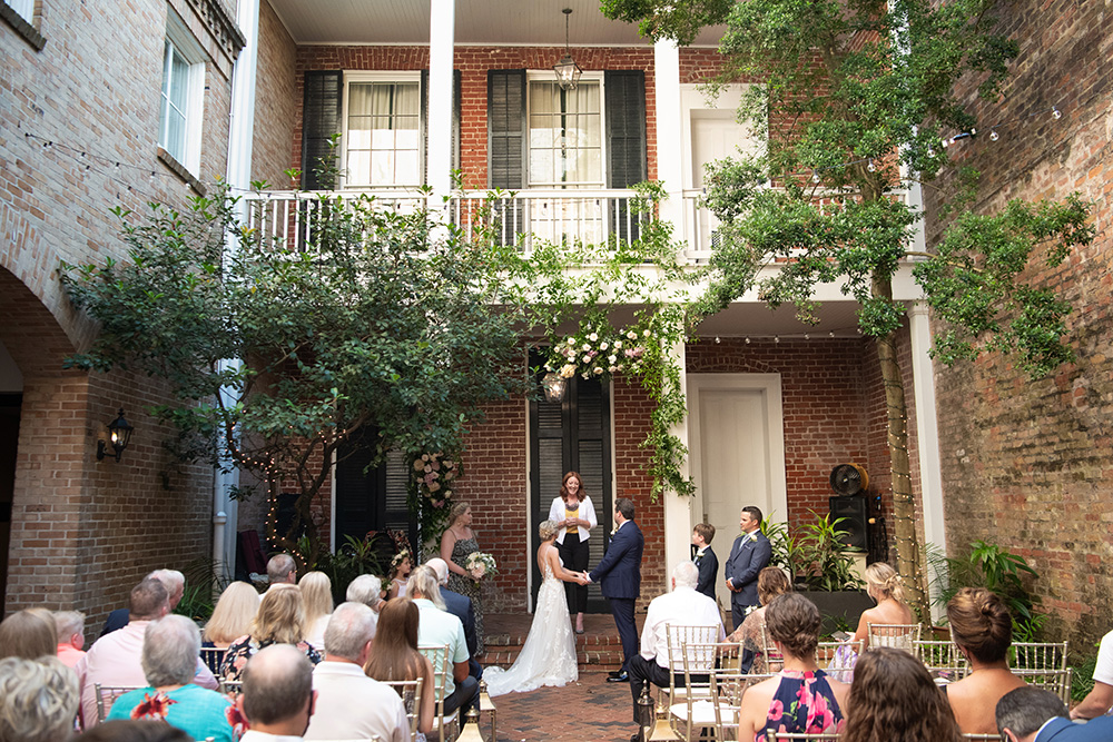 The wedding ceremony took place in the courtyard at Chateau LeMoyne in the French Quarter