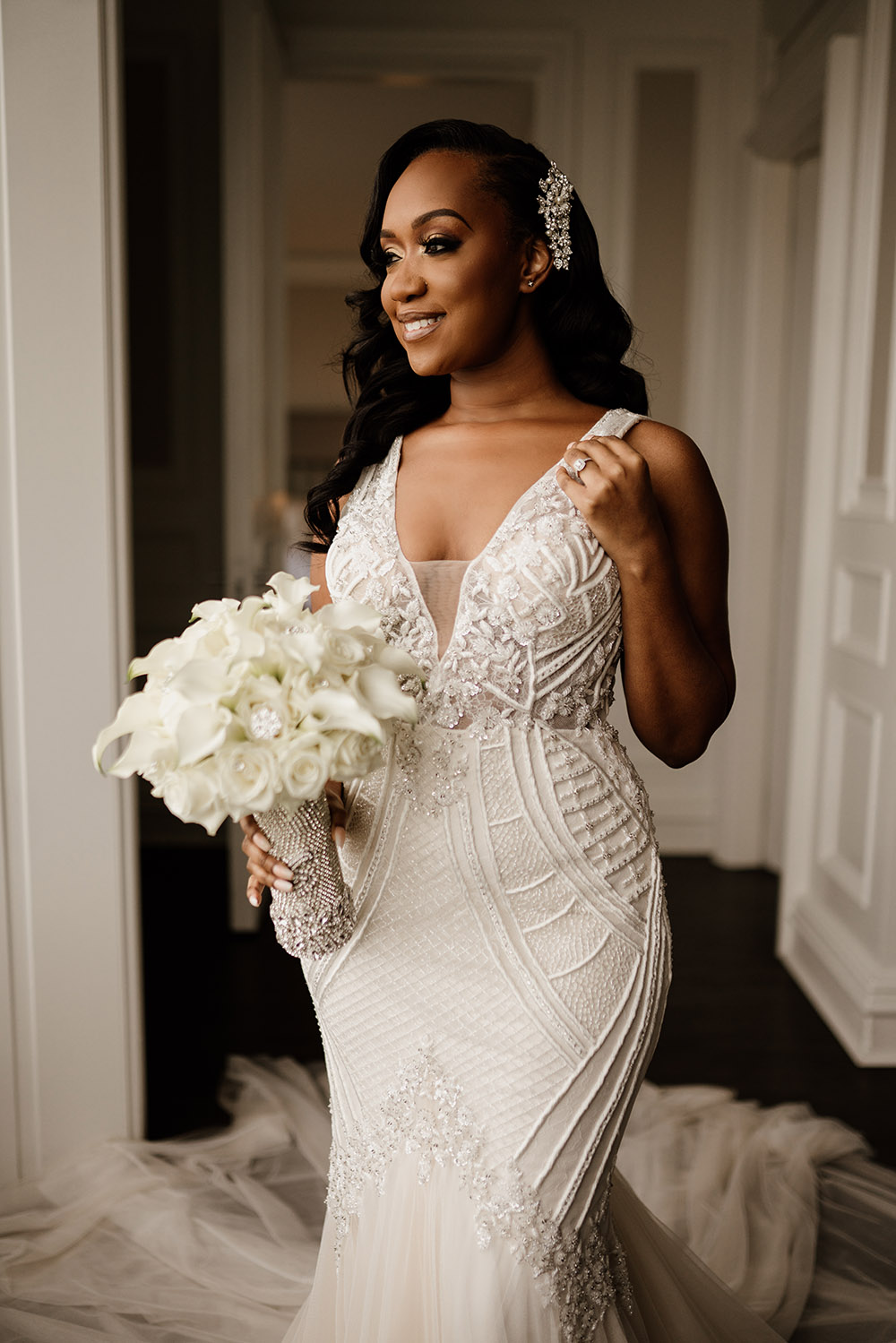 Shemia wore a beautiful Badgley Mischka gown and carried a bouquet of white roses and lilies. | Photo by Audie Jackson
