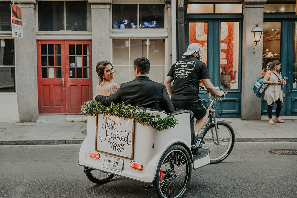 The couple take a pedicab ride around the French Quarter after their ceremony. Photo: Sara Ann Green Photography