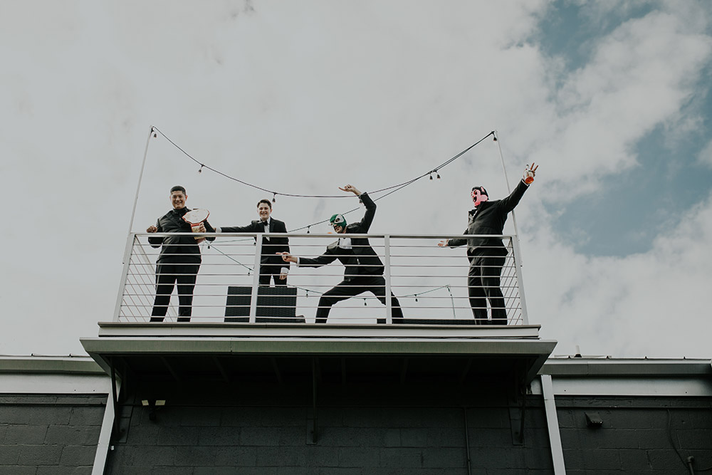 Chris and the groomsmen have fun on the rooftop of their AirBnB before the wedding. Photo: Sara Ann Green Photography