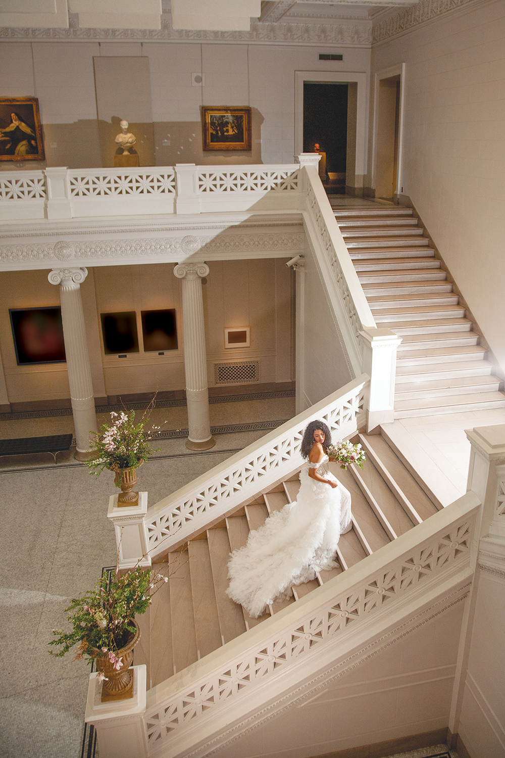 Lyn ascends the grand staircase in the New Orleans Museum of Art Freeport-McMoran Great Hall.
