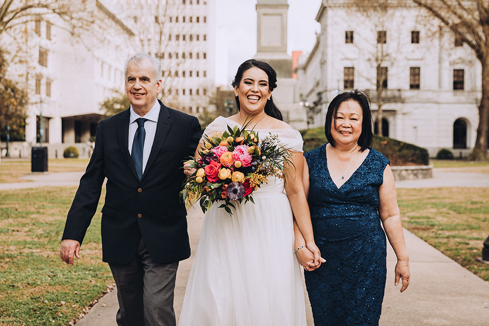 Isabella and her parents walk down the "aisle" at Lafayette Square.