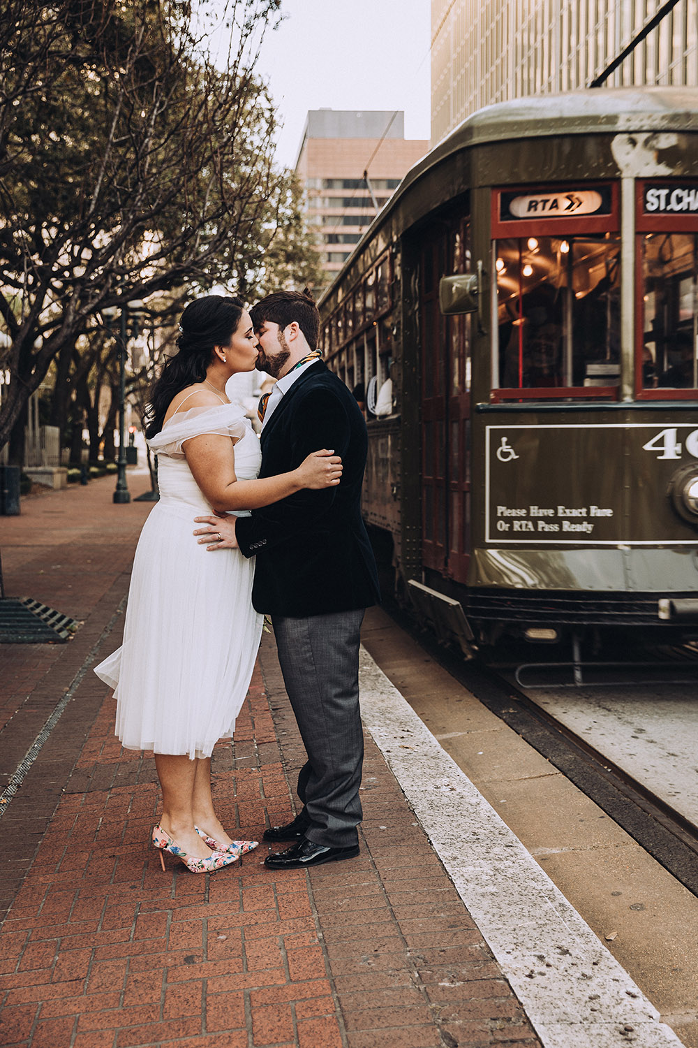 Isabella and Erik kiss as the St. Charles Streetcar passes.