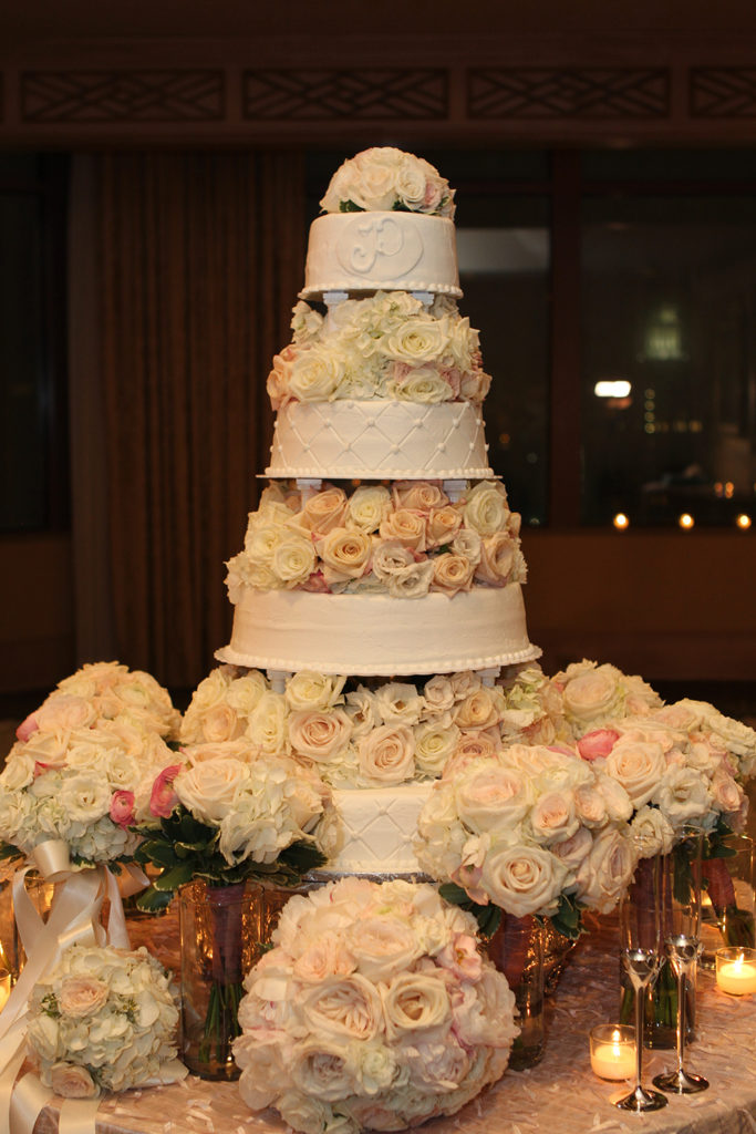 Four tier wedding cake with fresh flowers between tiers by Haydel's Bakery | Photo by Jessica The Photographer
