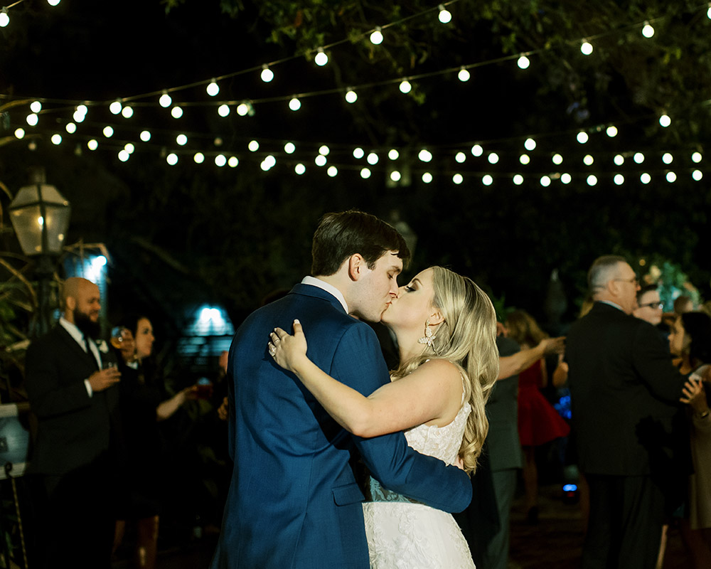 The couple kiss at the end of the reception