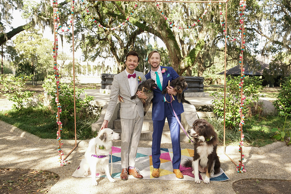 Christopher and Kyle pose for wedding photos with their four dogs