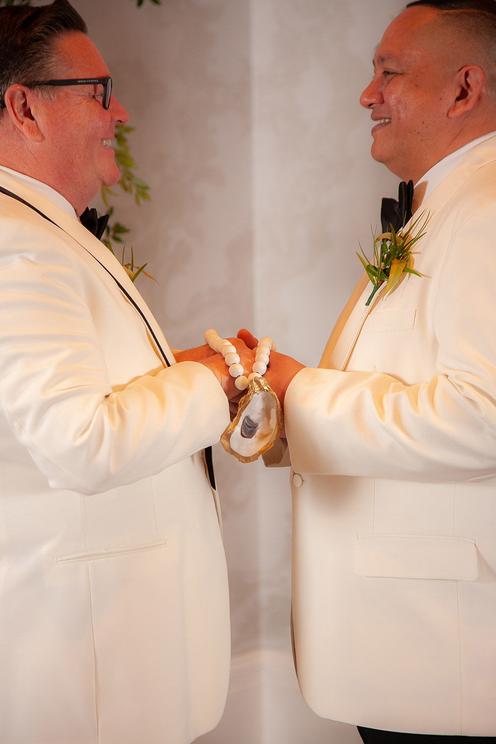 the grooms hold hands