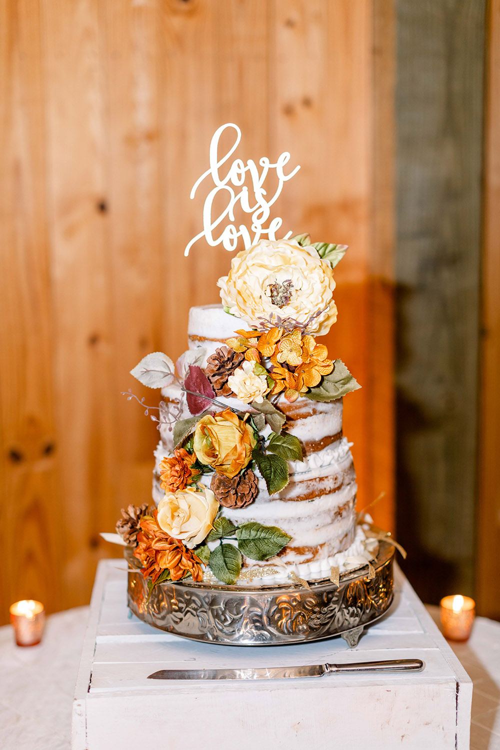 "naked" wedding cake with love is love cake topper