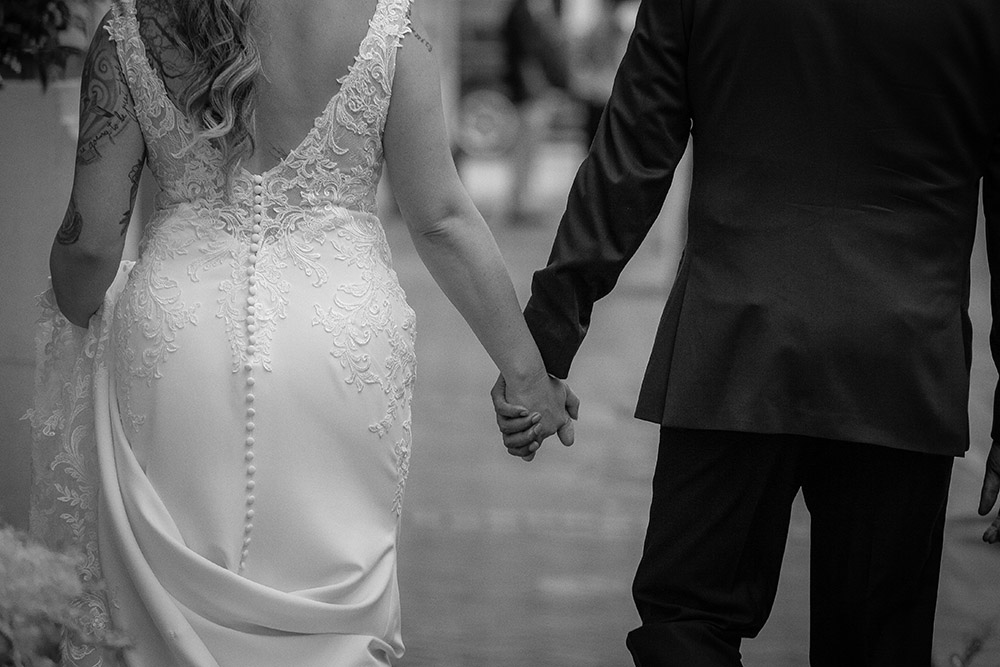 Bride and Groom hold hands
