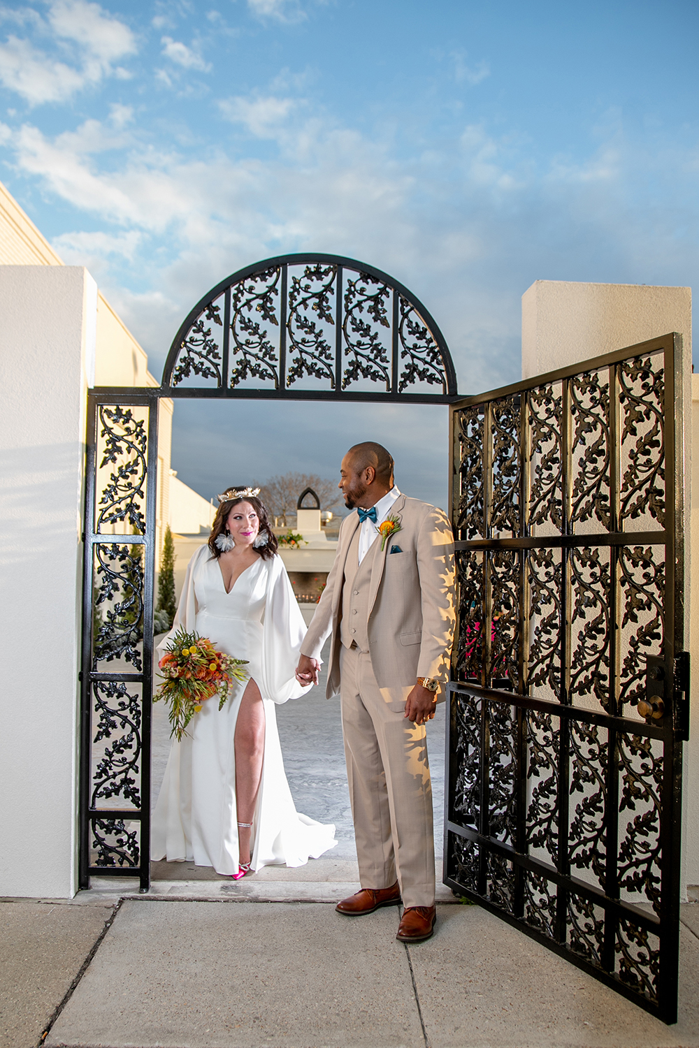 the bride and groom walk thru The Moore's wrought iron courtyard gate