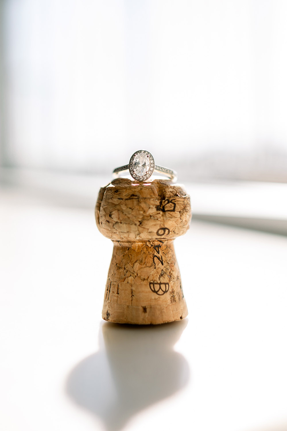 engagement ring on a champagne cork