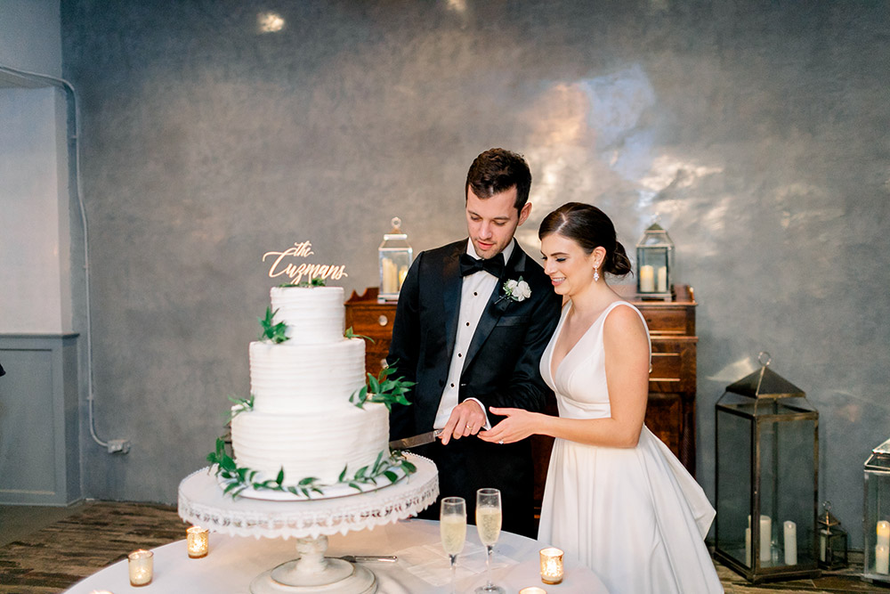 the newlyweds cut the wedding cake