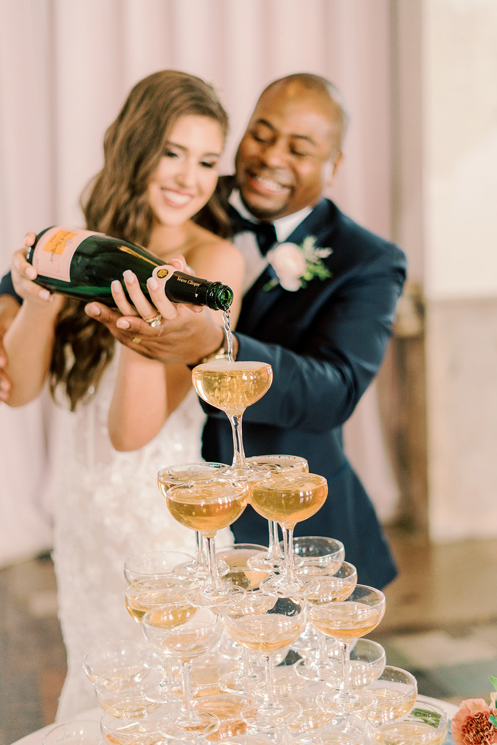 bride and groom champagne tower pour