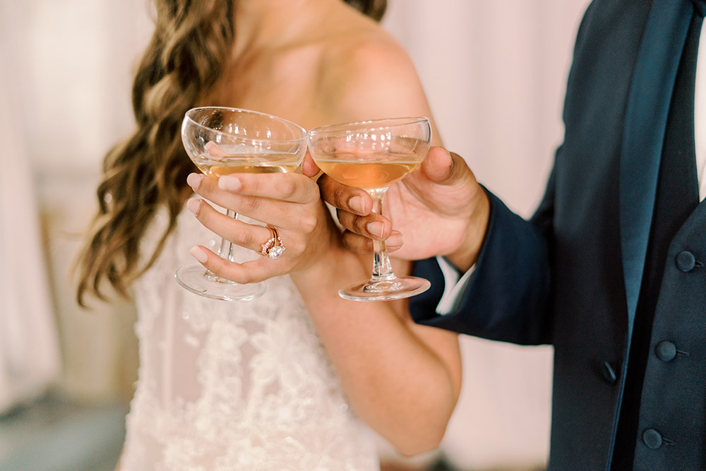 bride and groom toast with champagne coupes