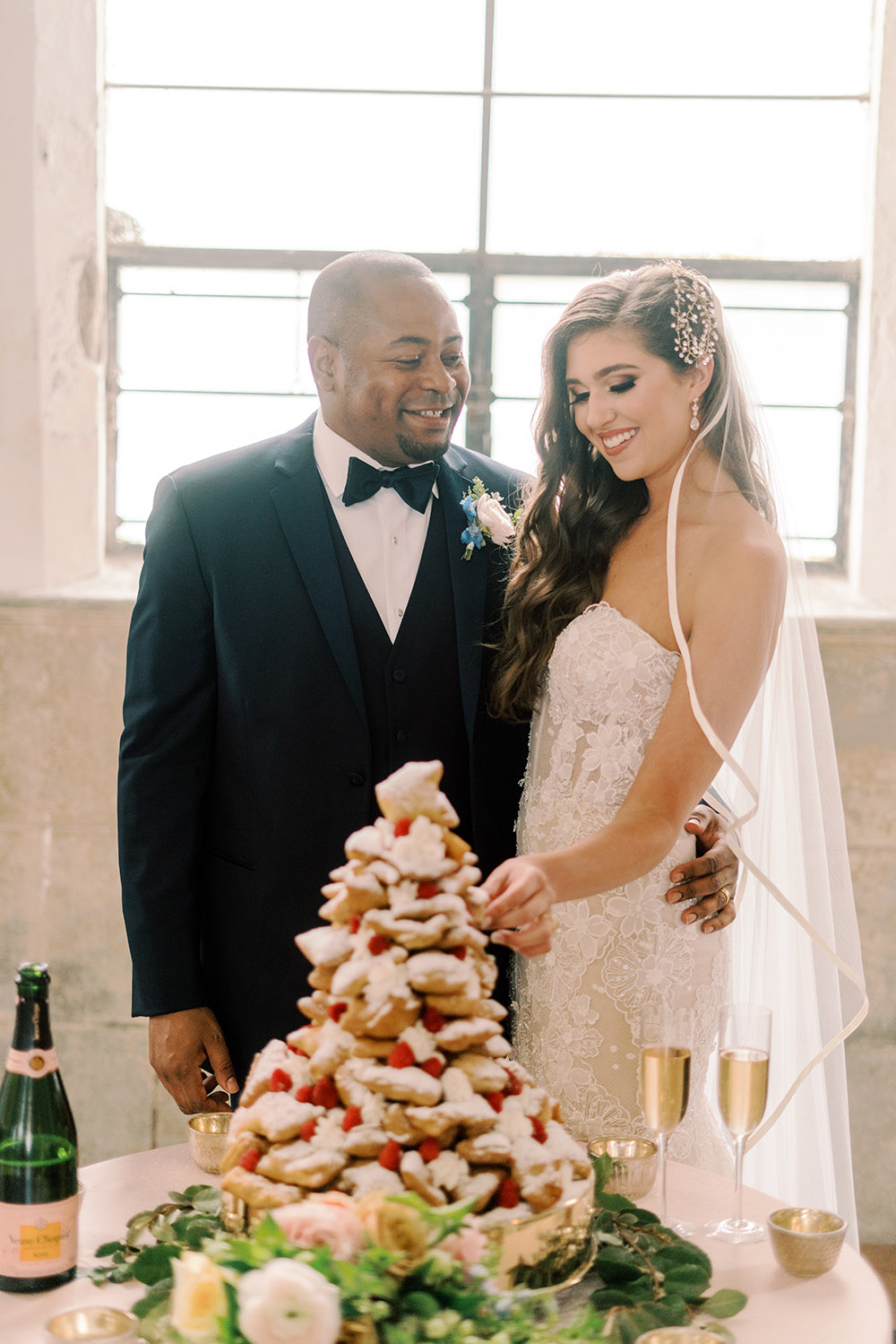 bride and groom with beignet tower groom's cake