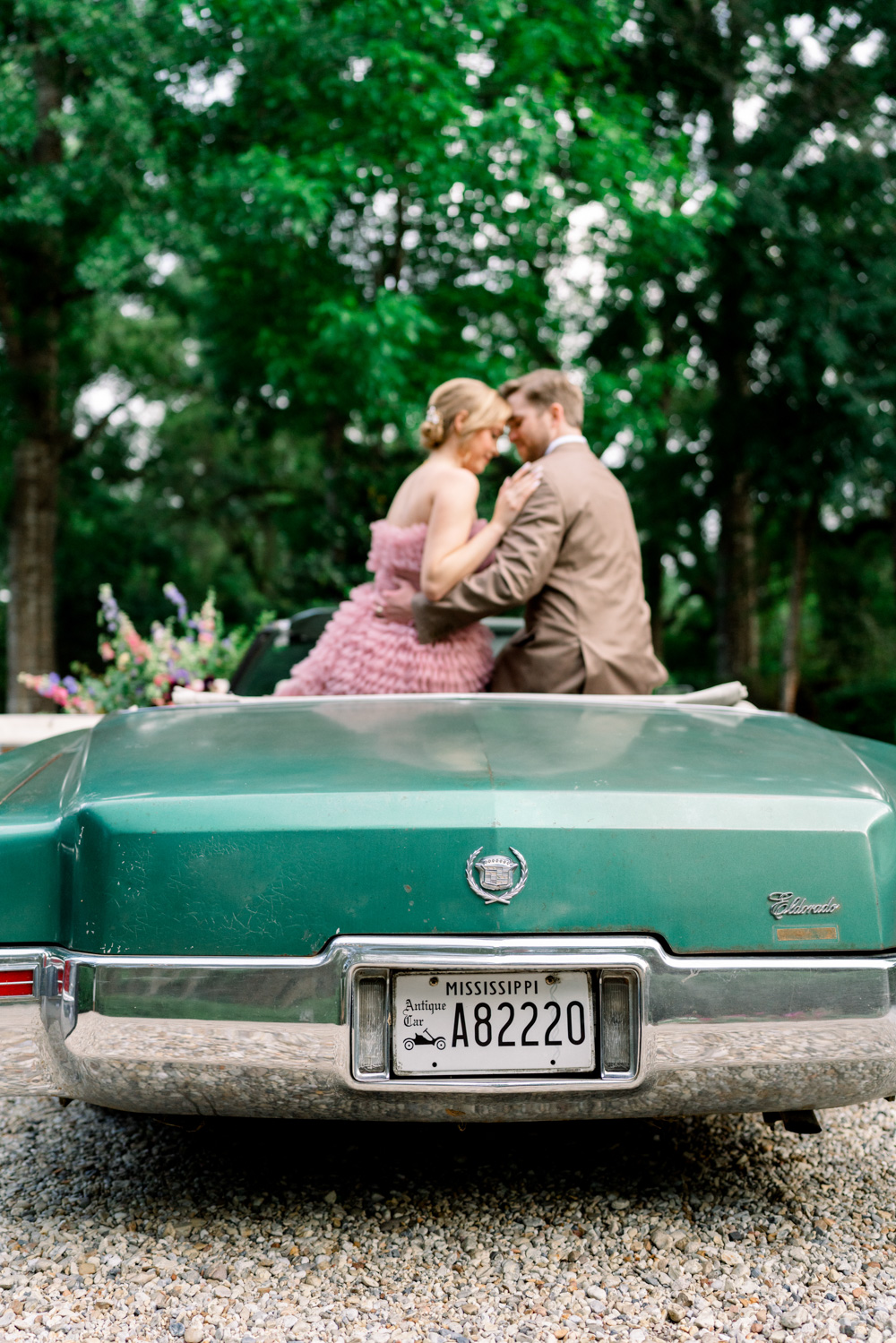 antique convertible car with wedding flowers