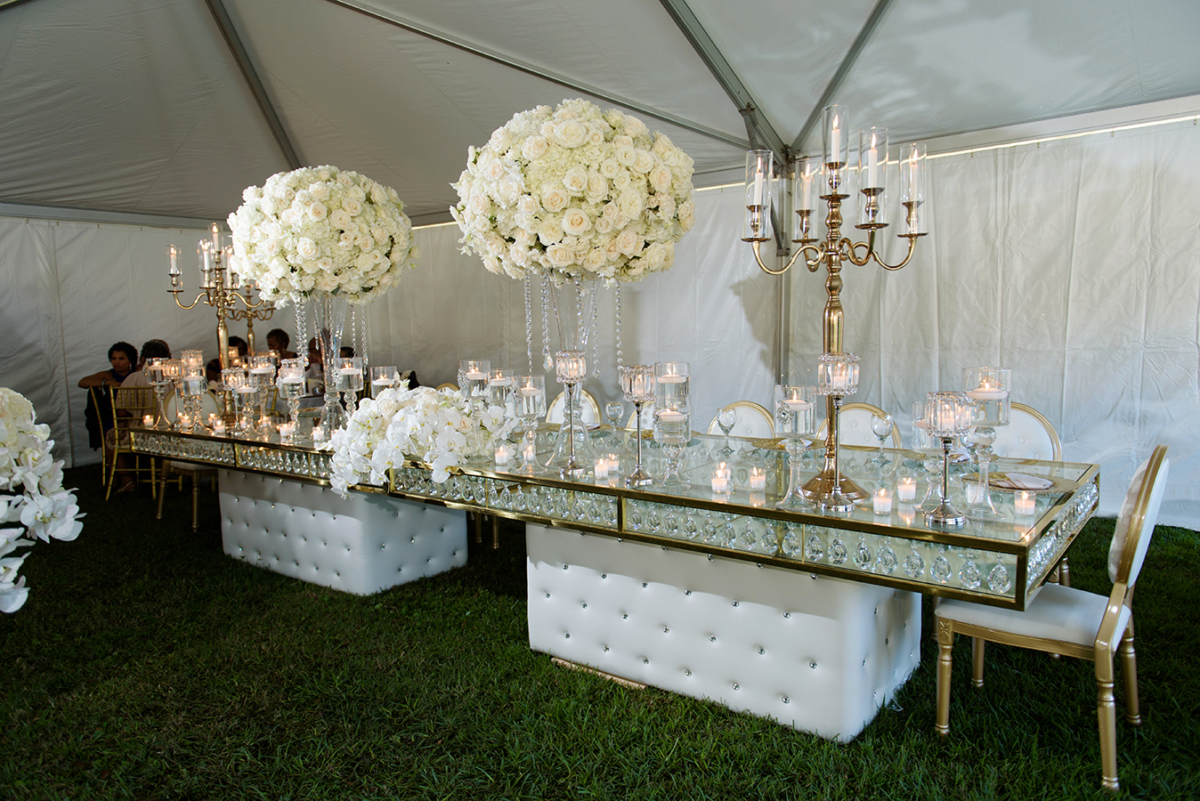 The mirrored bridal party table featured lush floral arrangements and gold candelabra.
