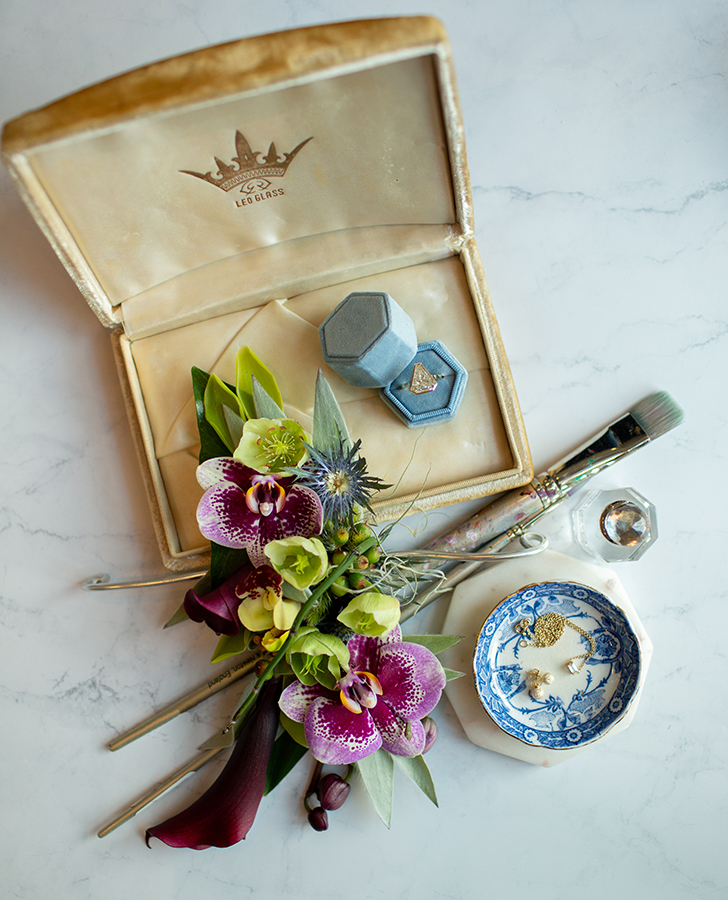 A wearable floral arm band from Mitch’s Flowers, 14k yellow gold bezel set shield diamond ring, floating baguette diamond necklace and gold stardust studs from Brilliance in Diamonds. Photo by Sarah Alleman Photography.