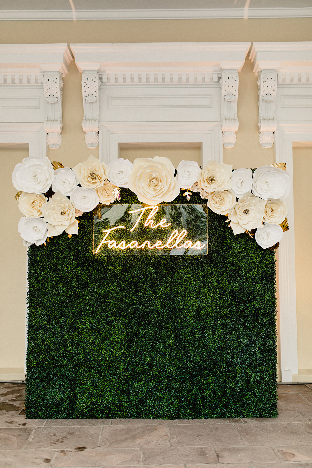 Nola Grace Decor's hedge wall photo opp with paper flowers and neon sign. Photo by Kristen Soileau.