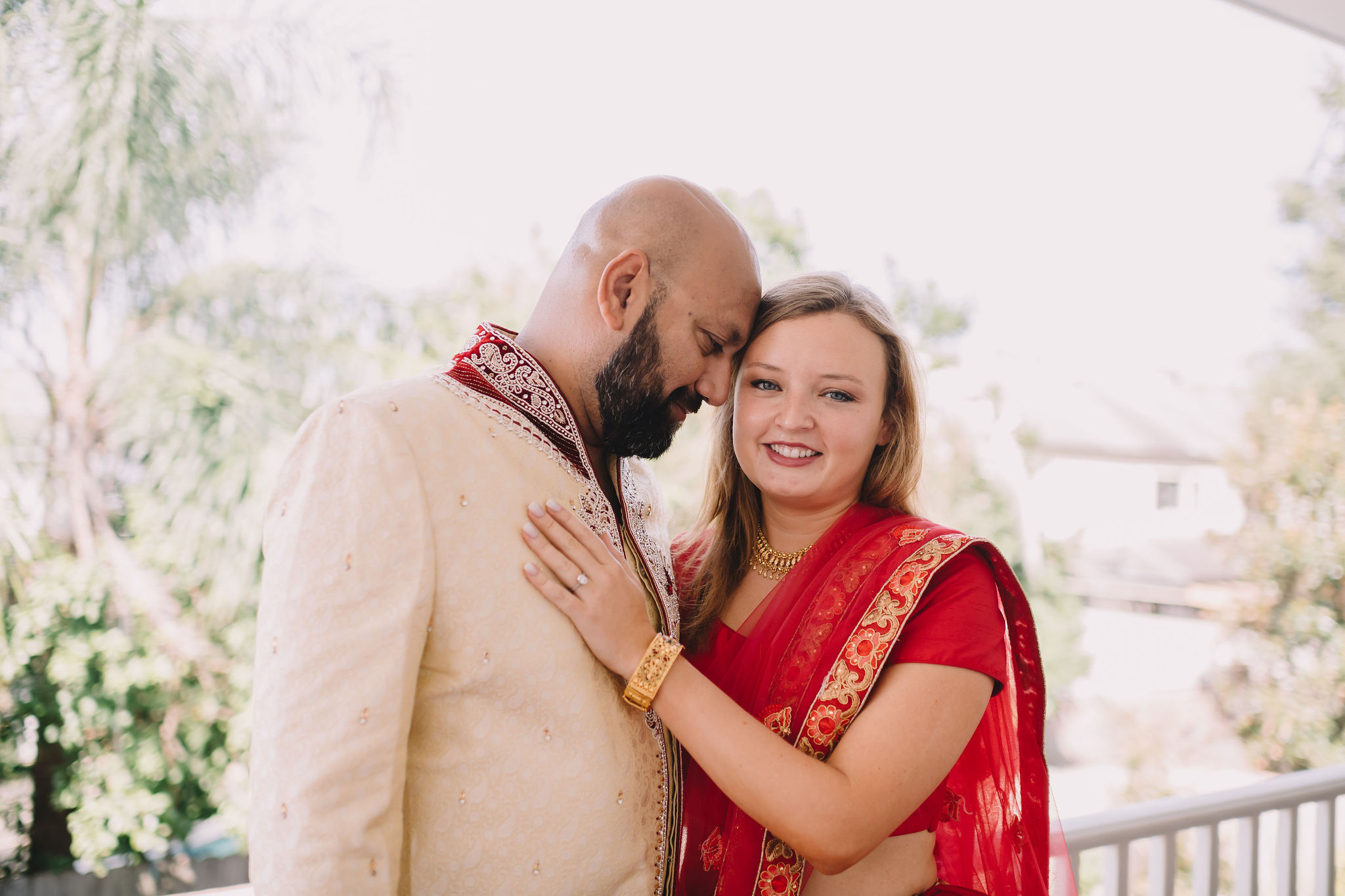 Rachel and Jimmy's wedding weekend included a Mehndi Party. For this event, Rachel wore a traditional Lehenga in red and gold and Jimmy wore a Sherwani with red embroidered detail.