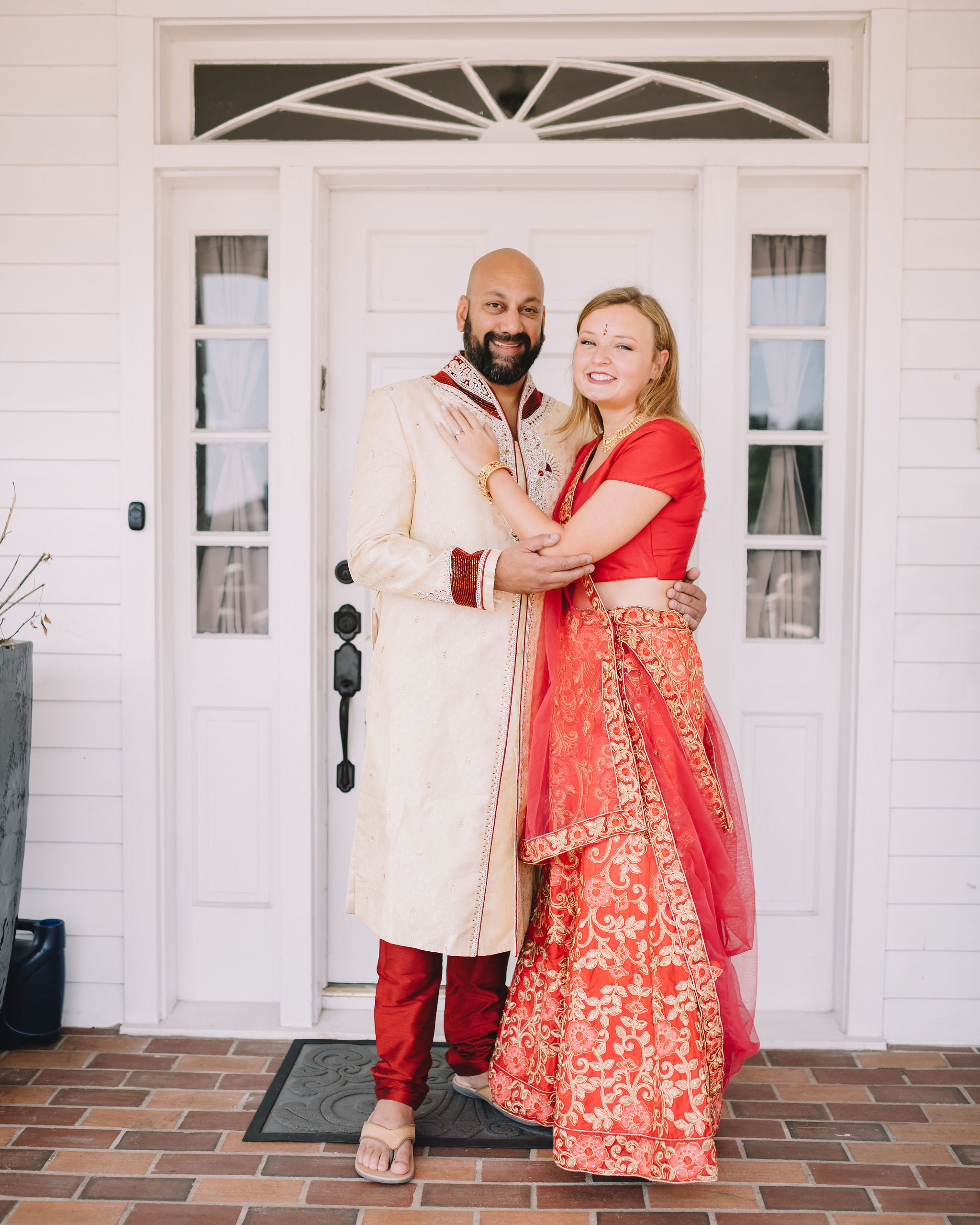 Rachel and Jimmy's wedding weekend included a Mehndi Party. For this event, Rachel wore a traditional Lehenga in red and gold and Jimmy wore a Sherwani with red embroidered detail.