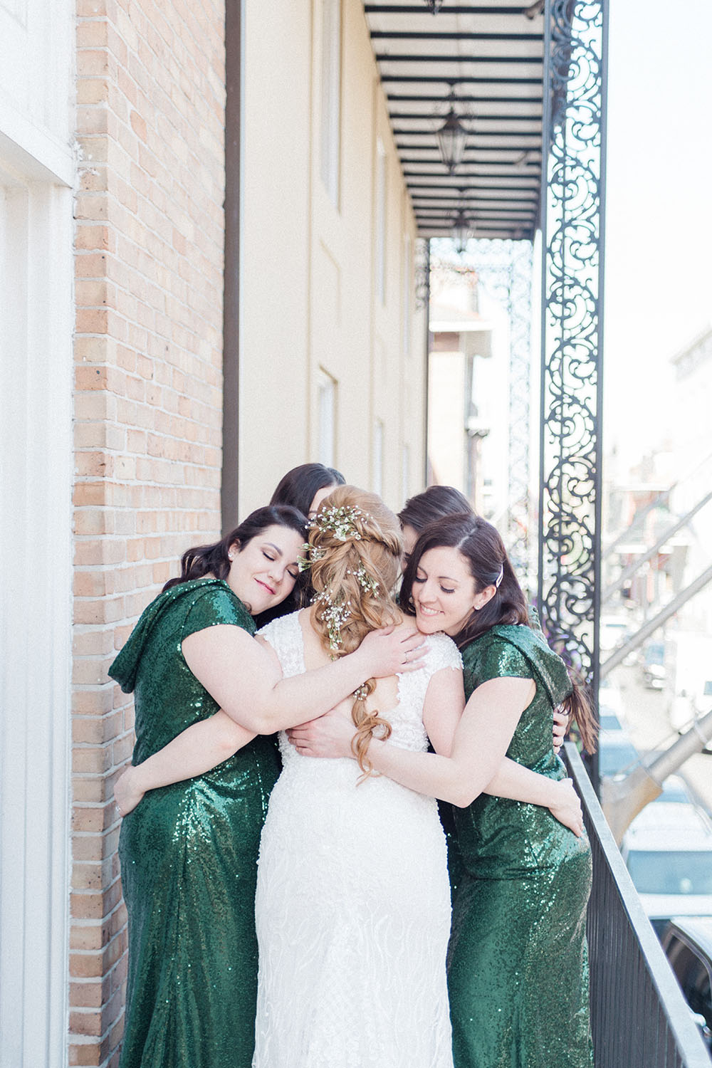 bride hugging bridesmaids on wedding day