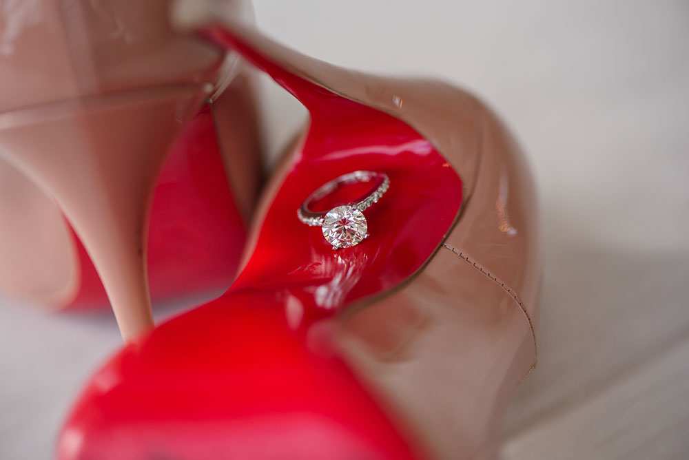 artistic shot of engagement ring and shoes