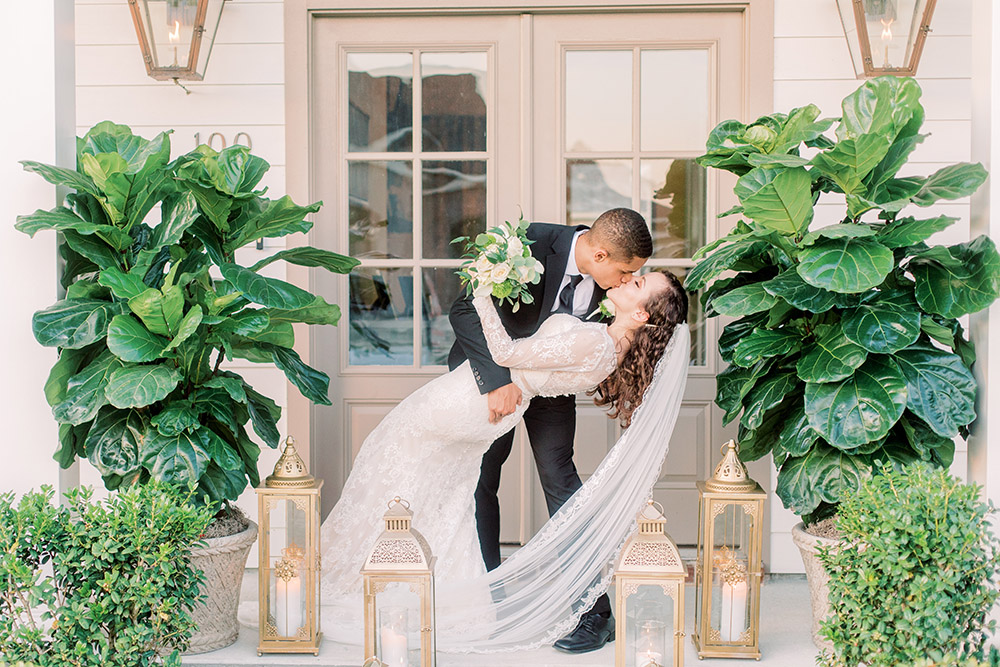 The groom dips and kisses his bride. Photo: Ashley Kristen Photography