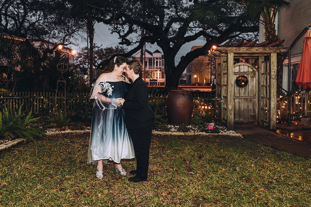 brides pose in the garden at Canal Street Inn in New Orleans