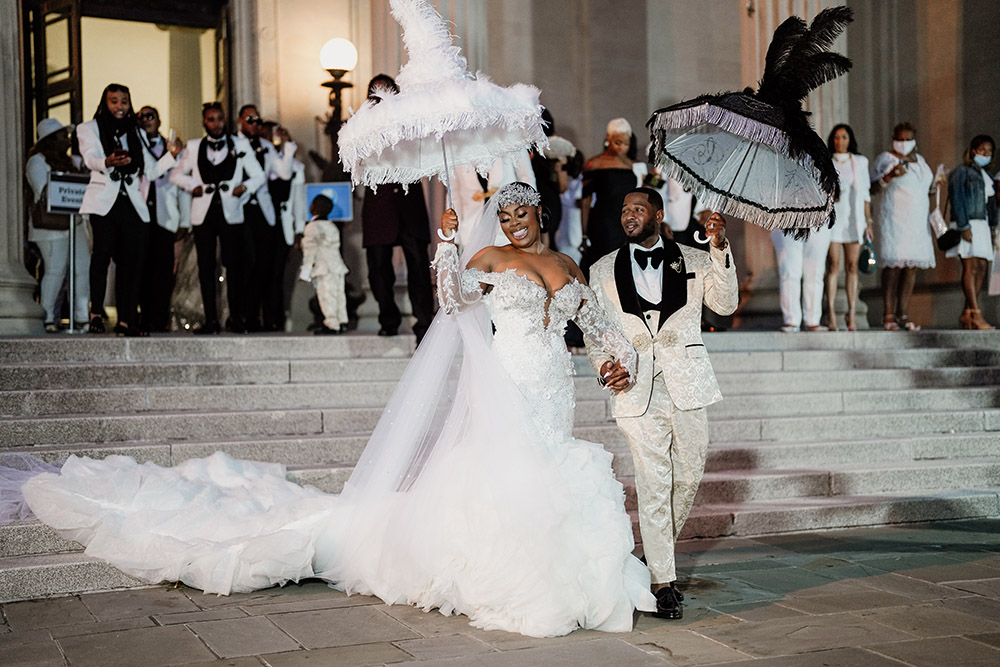 The bride and groom Second Line out of the New Orleans Museum of Art after the wedding ceremony.