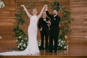 The bride and groom celebrate at the altar