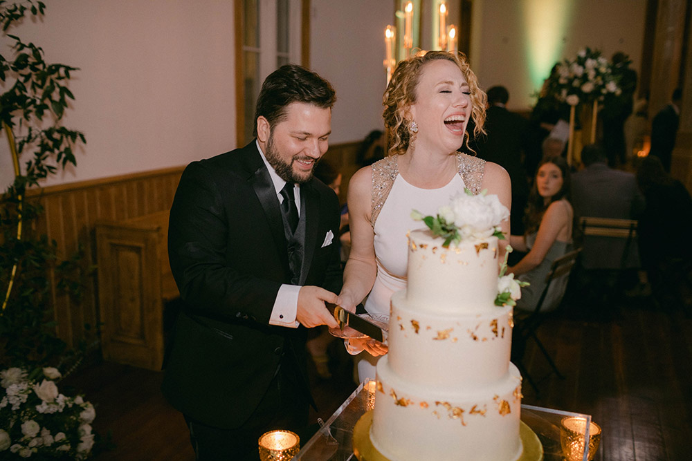 the bride and groom cut the cake