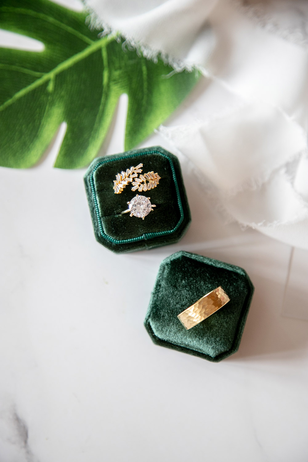 wedding and engagement rings in green velvet box