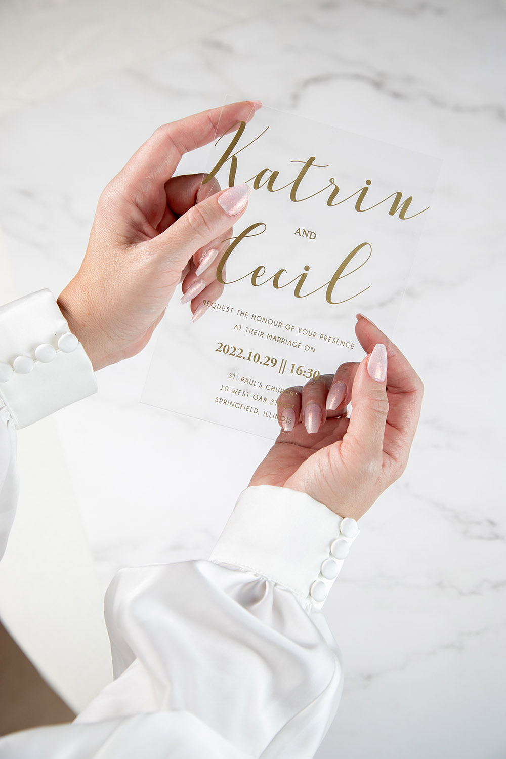 clear acrylic wedding invitation with gold lettering