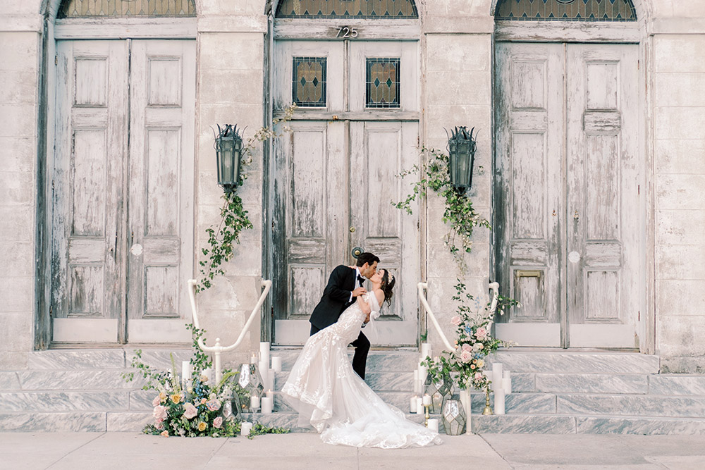 bride and groom on the steps of the Marigny Opera House
