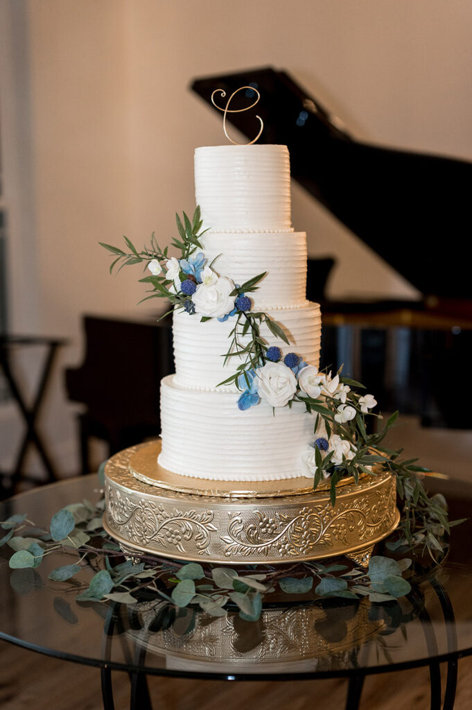 white wedding cake with white and blue flowers